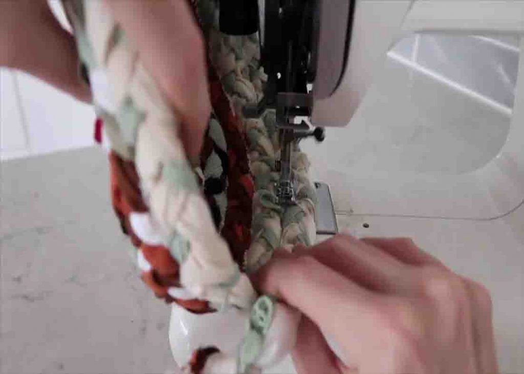 Sewing the braid to make the DIY fabric basket