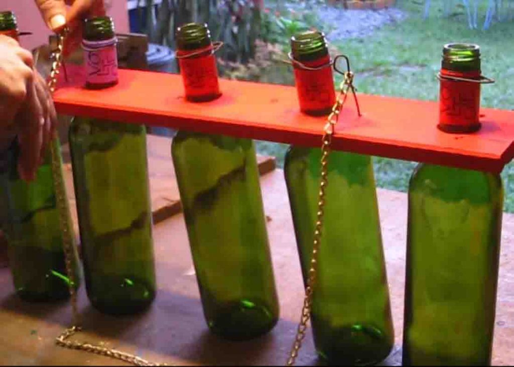 Attaching the hang of the DIY Christmas lights using wine bottles