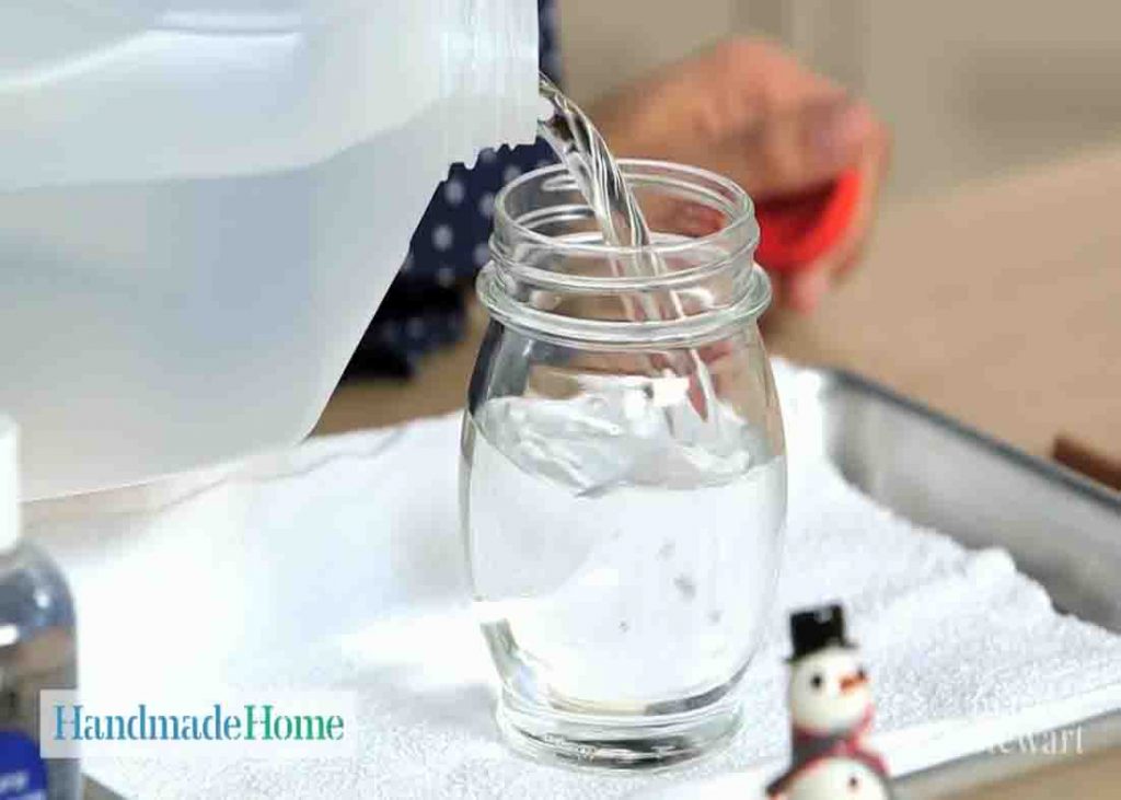 Filling the jar with water and glycerin for the homemade snow globe