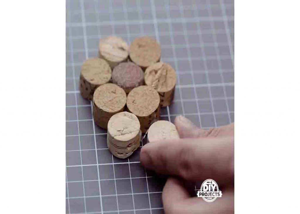 Gluing the wine cork pieces together to make a placemat