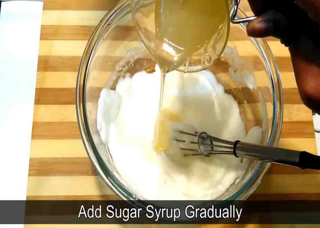 Adding the sugar syrup gradually to the homemade whipped cream
