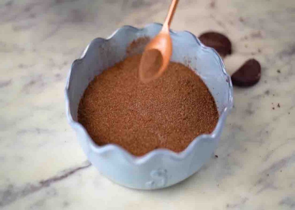 Adding the cocoa powder mixture over the hot fudge cake