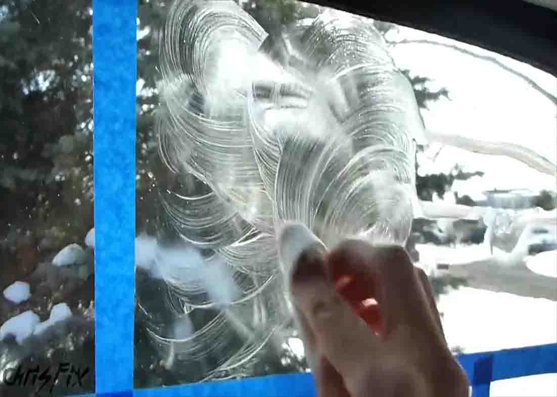 Distributing the shaving cream over the glass to defog it
