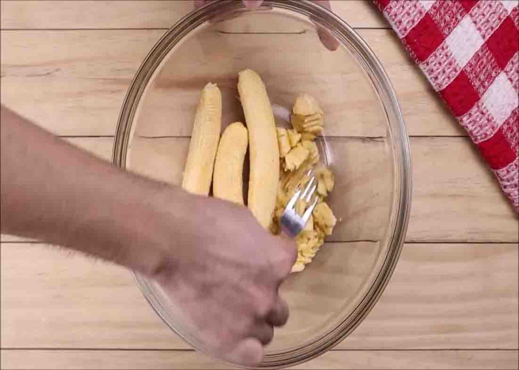 Mushing the bananas for the banana chocolate chip loaf recipe