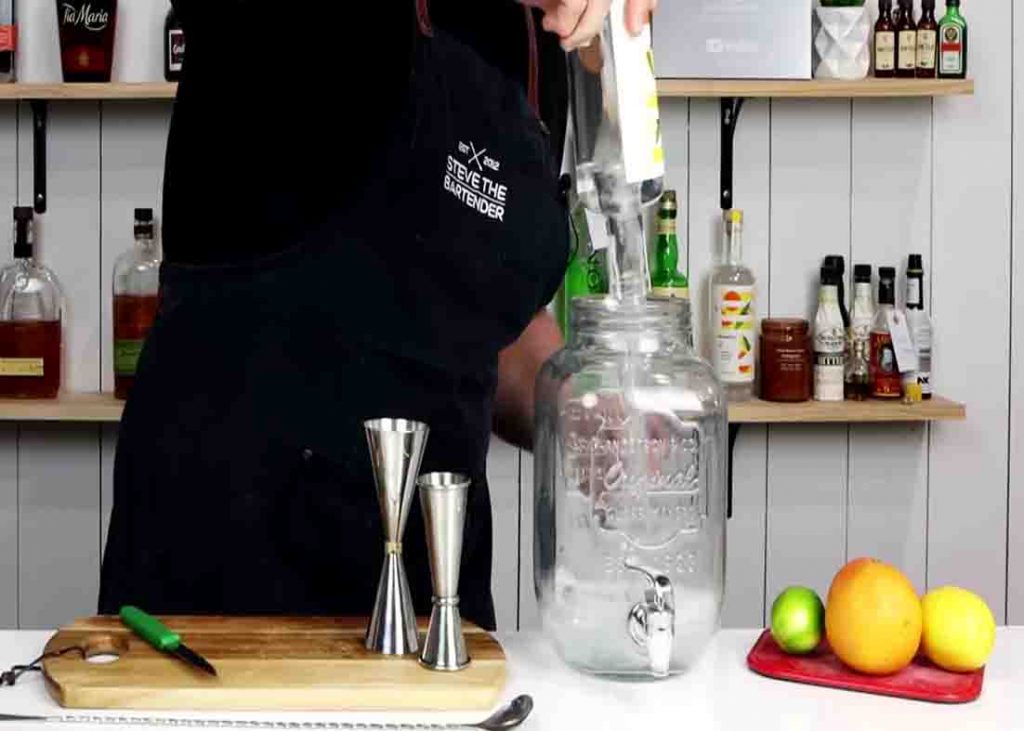 Pouring the gin to the drink dispenser