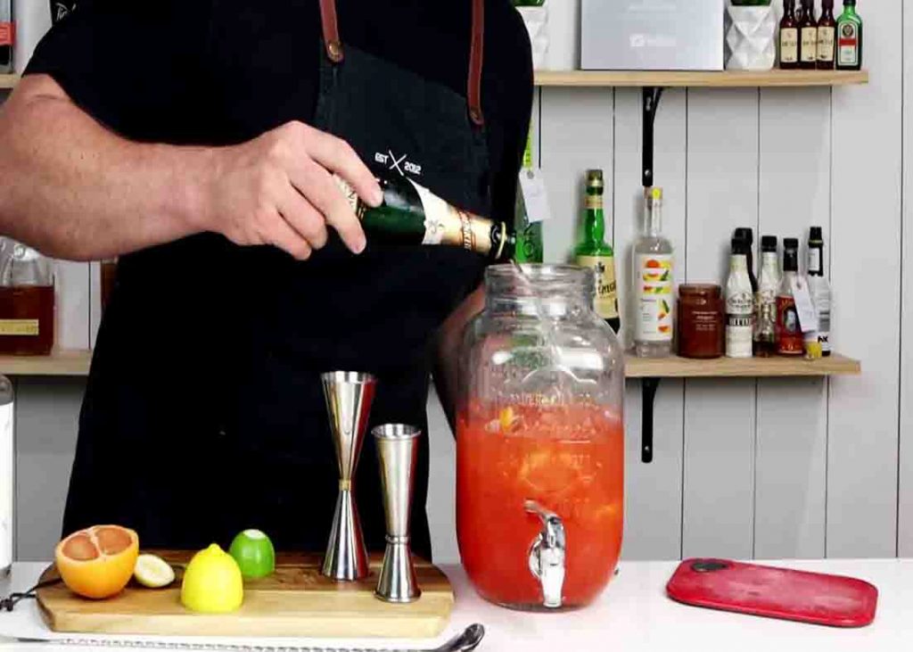 Pouring the sparkling wine to the gin mixture