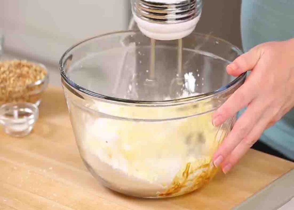 Combining all the snowball cookies ingredients to a bowl
