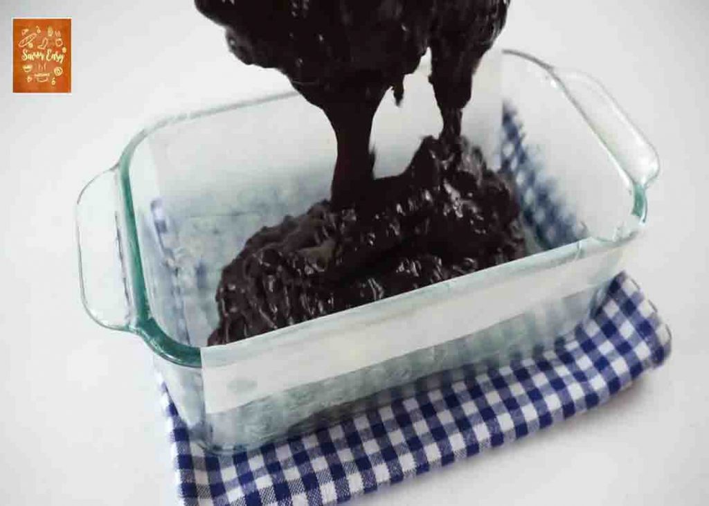 Pouring the chocolate bread mixture to the loaf pan