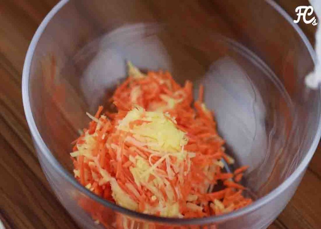 Grating the potatoes and carrot to make the fritters