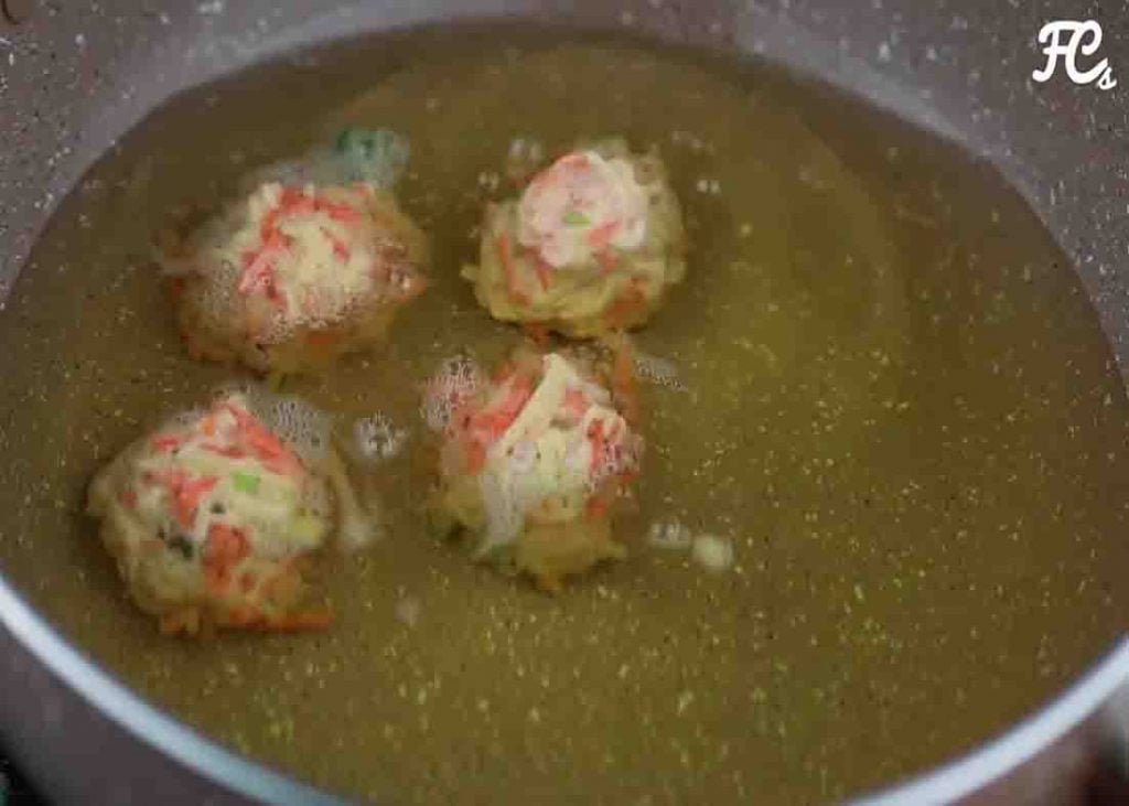 Frying the potato and carrot fritters