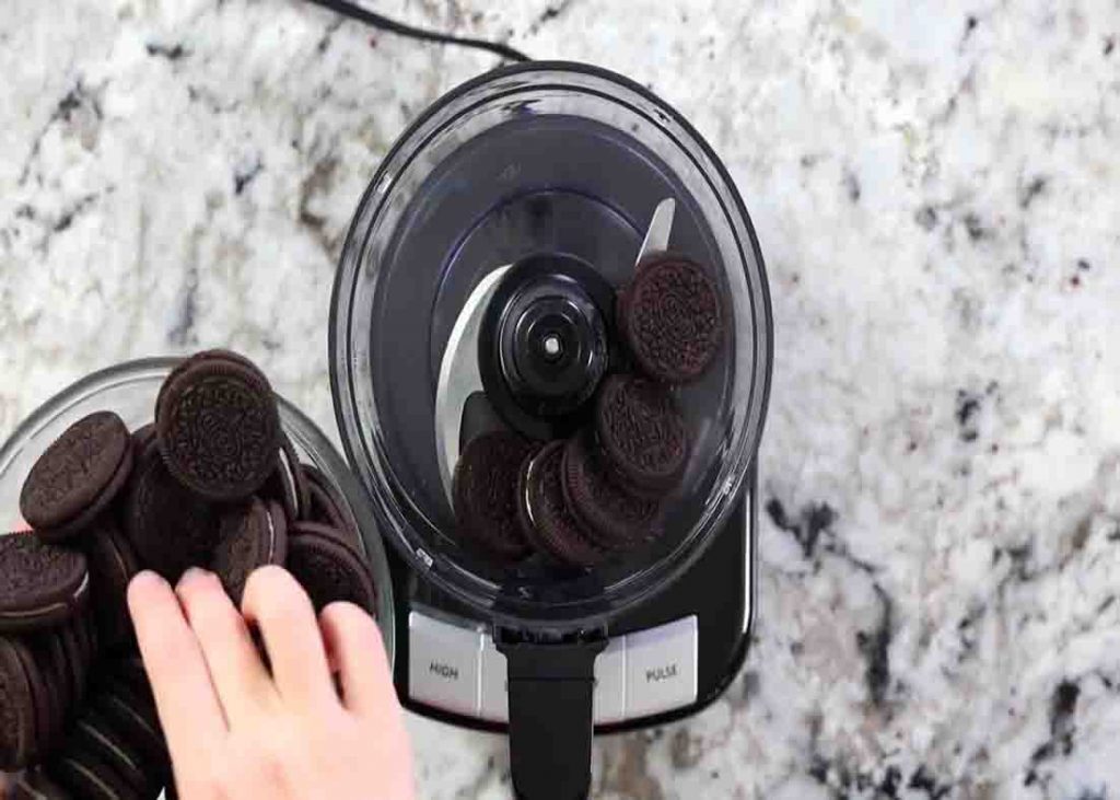Adding the Oreo cookies into the food processor