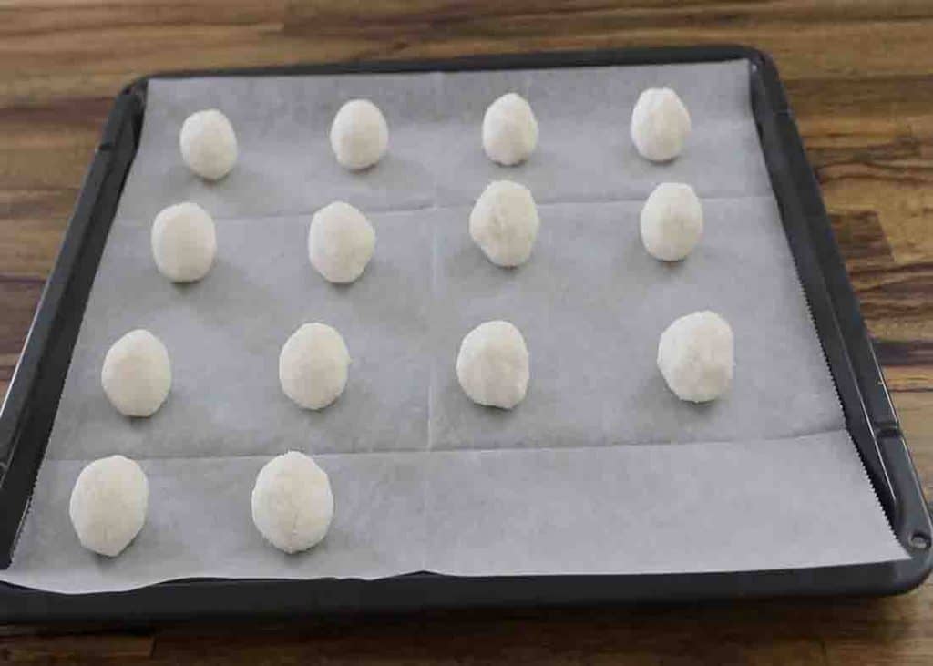 Arranging the coconut cookies to the baking tray