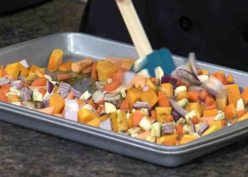 Stirring the veggies to make sure they're evenly coated with balsamic dressing