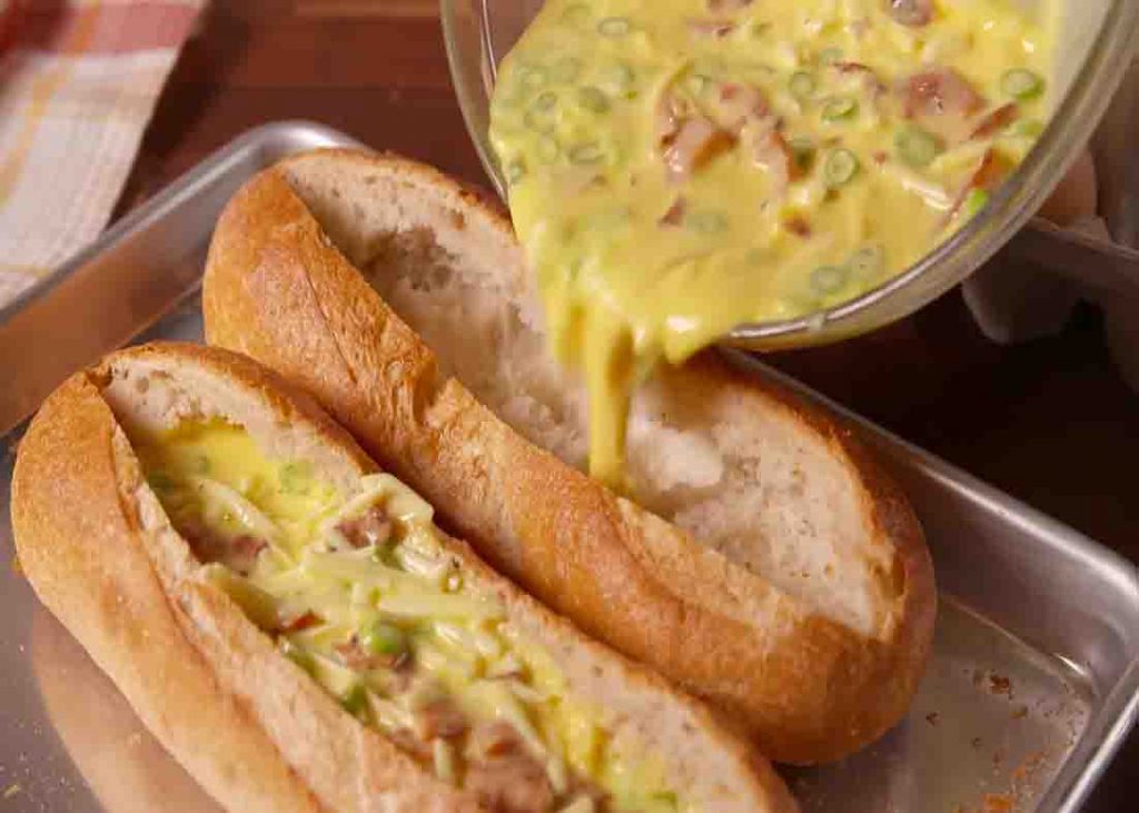 Pouring the egg mixture to the hollowed baguette