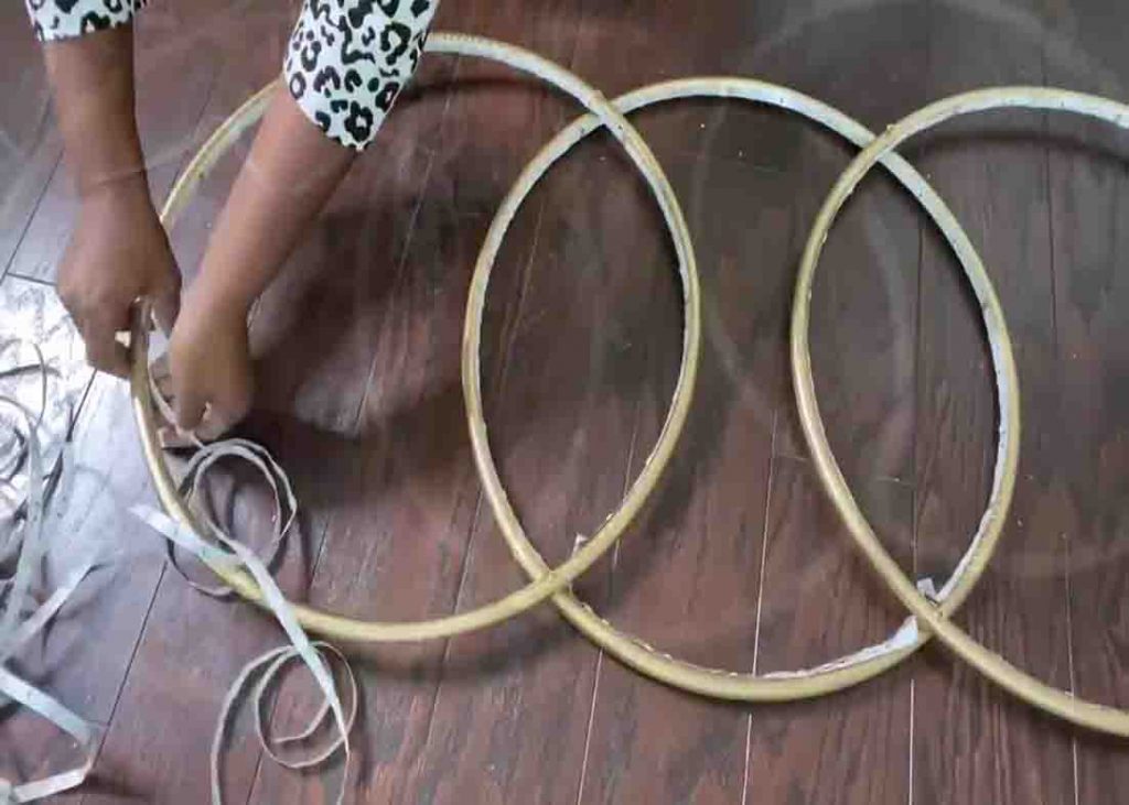 Attaching the LED strip lights to the hula hoops