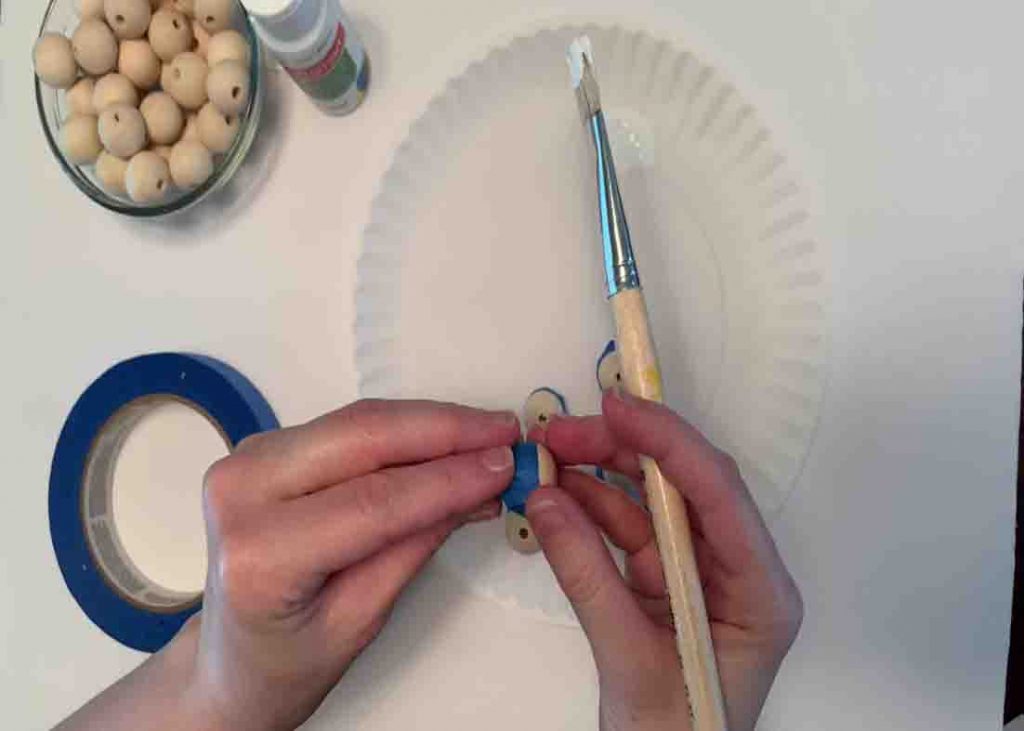 Painting the halves of the wood beads white