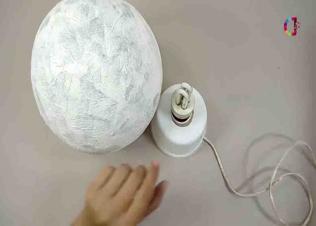 Attaching the bulb inside the DIY moon lamp