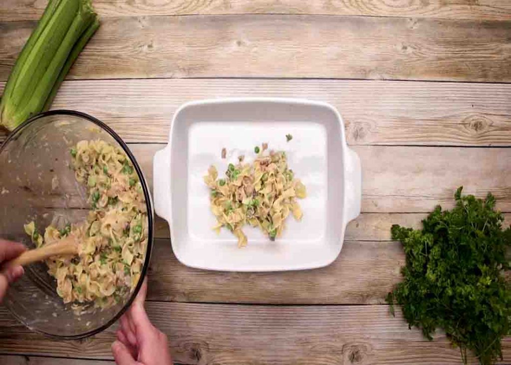 Transferring the tuna mixture into the casserole dish