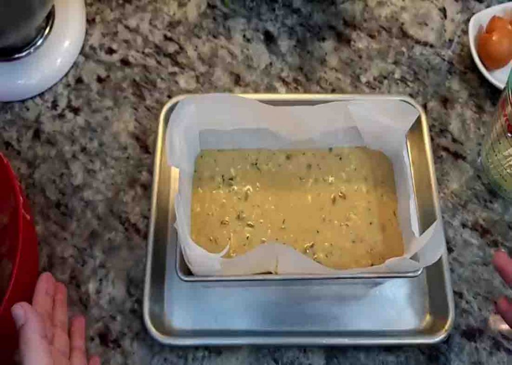 Putting the zucchini bread batter into the loaf pan