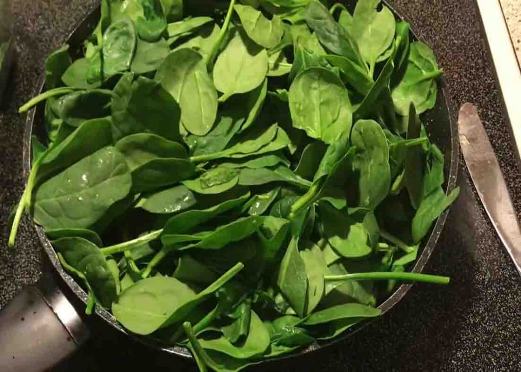 Sauteing the garlic butter spinach