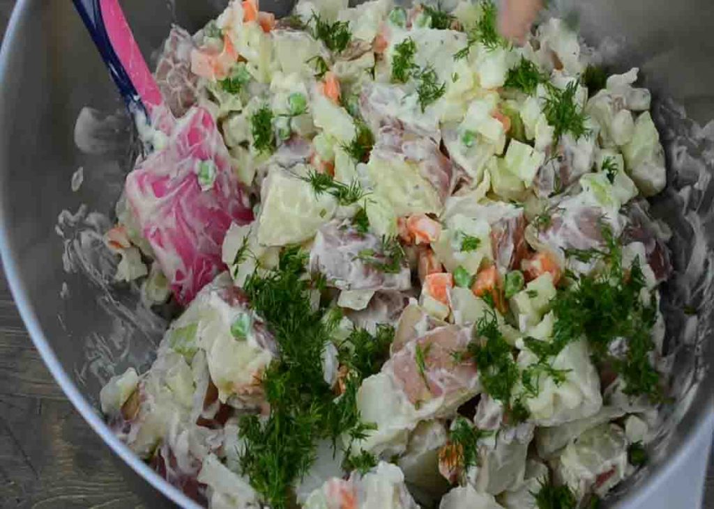 Tossing all the ingredients for the potato salad recipe