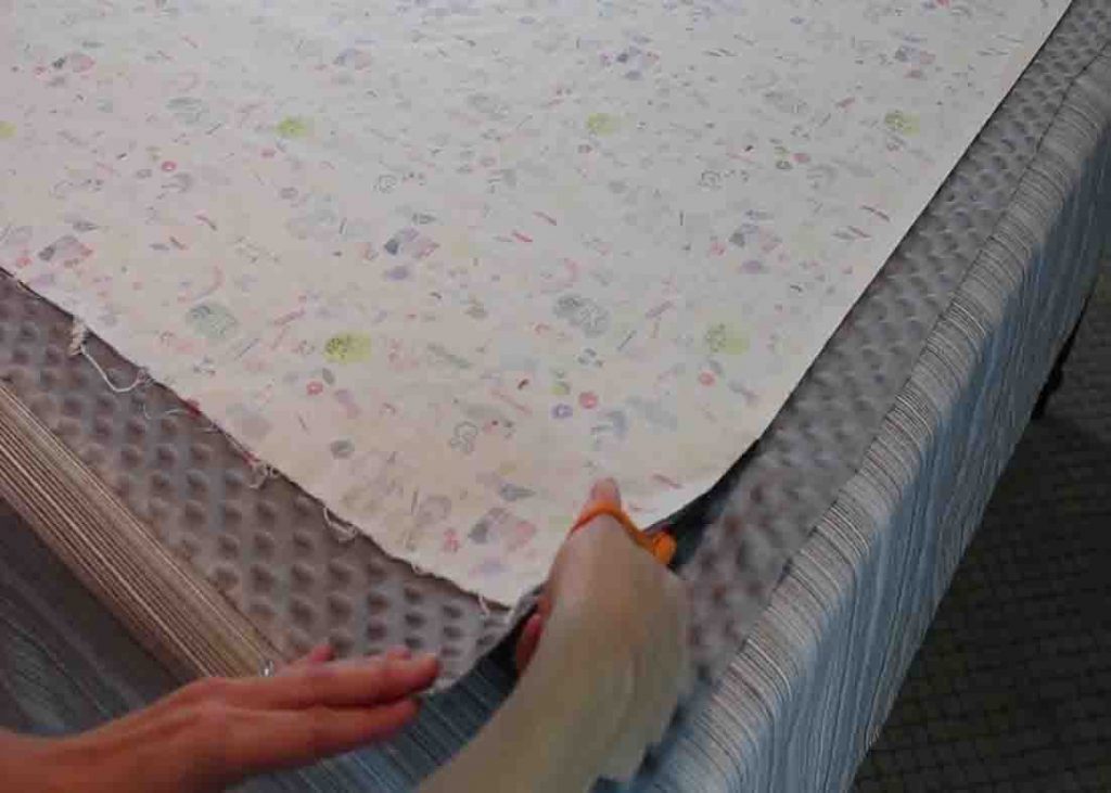 Cutting the minky around the cotton fabric for the baby blanket tutorial