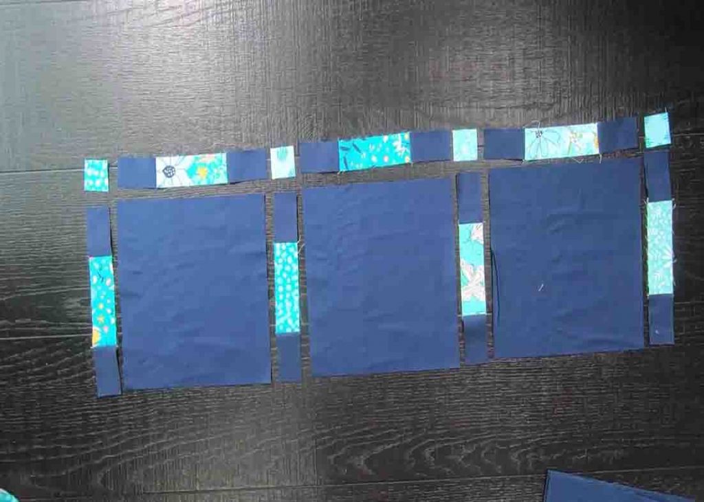Laying out the modern window quilt units to make the top