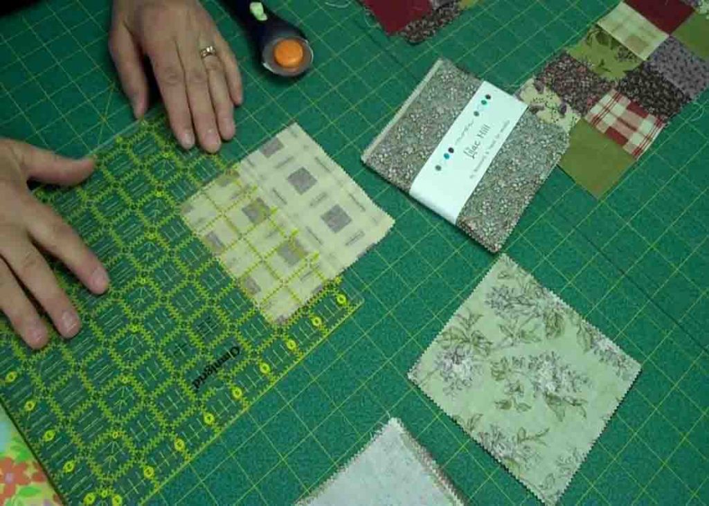 Cutting the pieces from the charm pack to make the scrappy 4-patch quilt