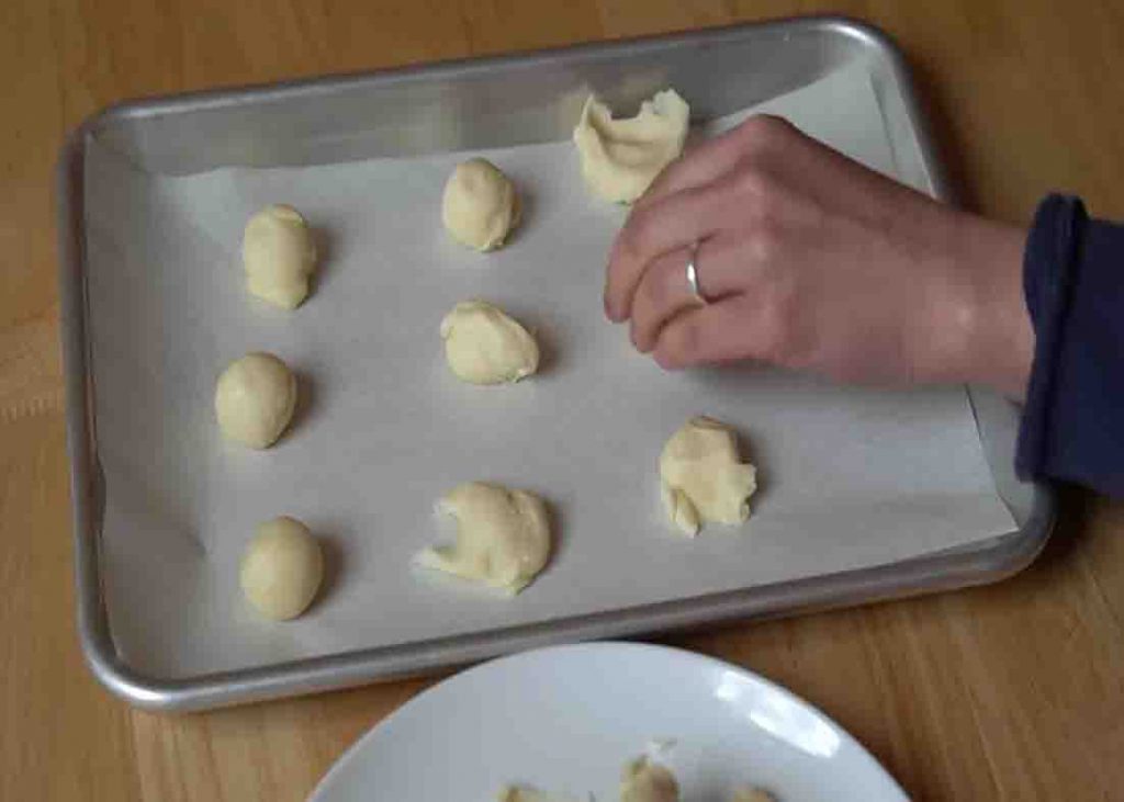 Putting the cookie dough on the baking sheet