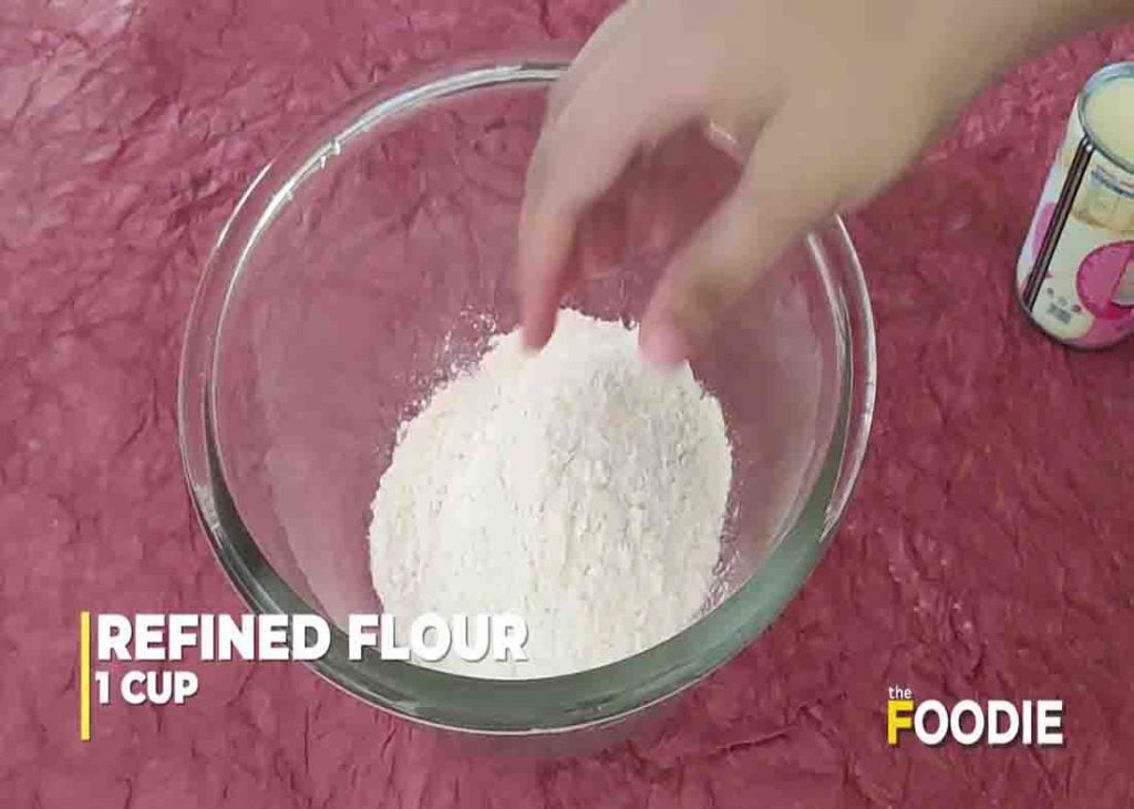 Mixing the flour and butter for the milk cookies recipe