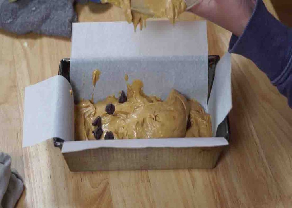 Pouring the cookie dough loaf batter to the loaf pan