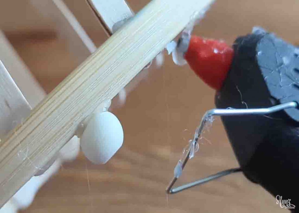 Gluing the wooden beads to finish the candle holder