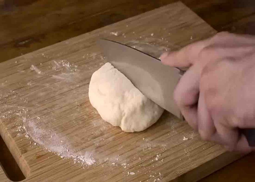 Dividing the pizza dough to two
