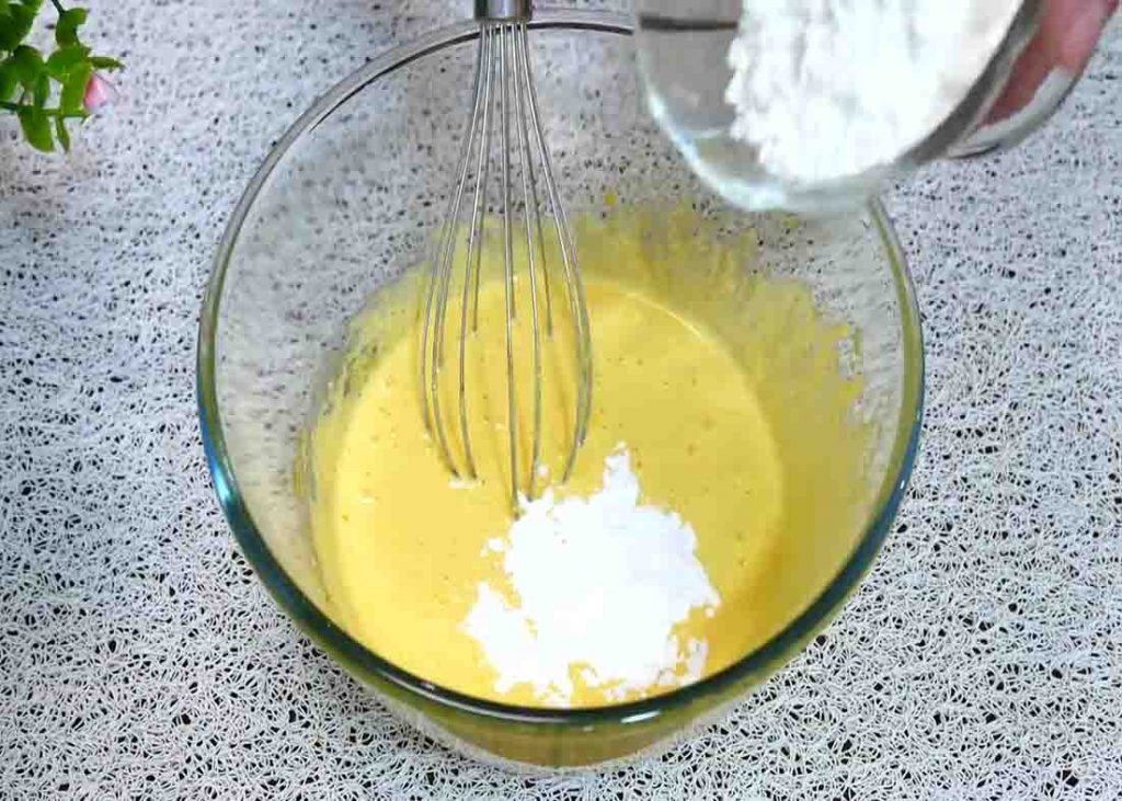 Mixing the yolks and flour for the yogurt cake recipe