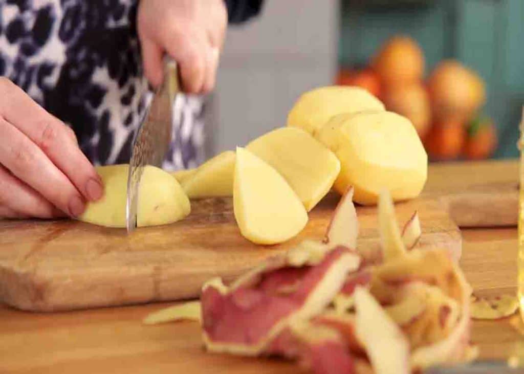 Chopping the potatoes into small chunks