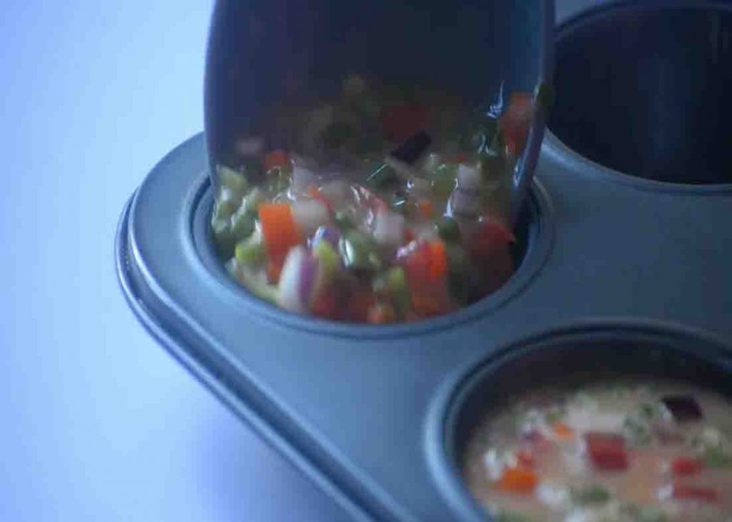 Pouring the egg mixture to the muffin tins