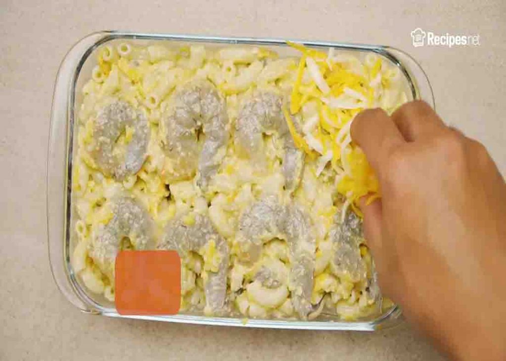 Topping the shrimp casserole with more cheese