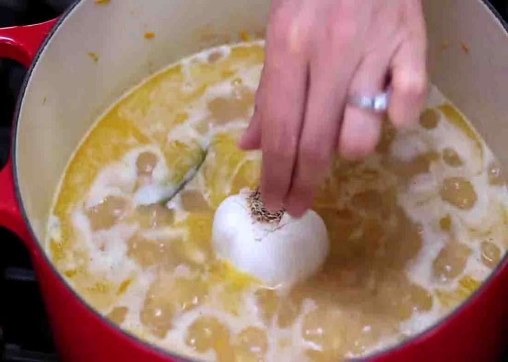 Adding one head of garlic on top of the rice