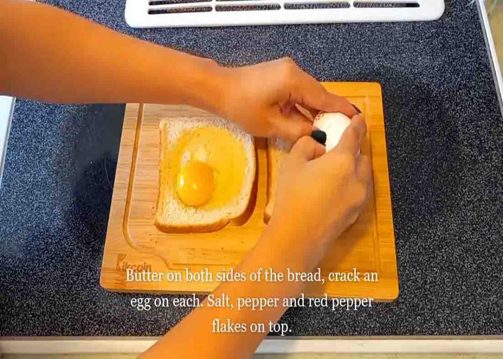 Cracking an egg on both slices of bread