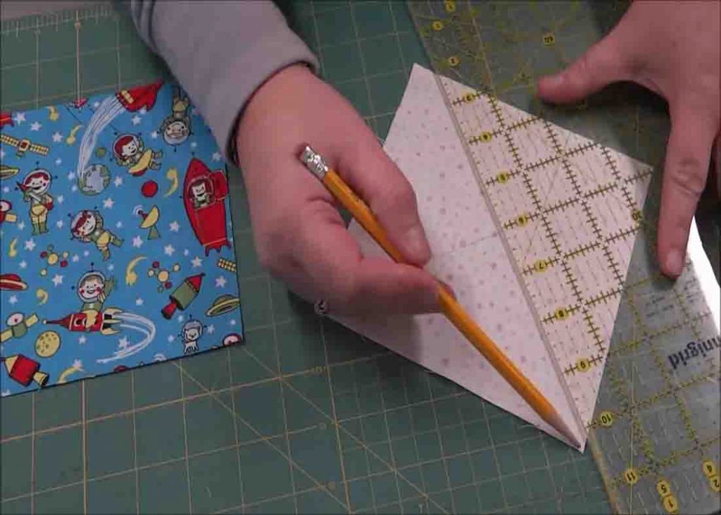 Drawing a line to the background piece of the I Spy Quilt