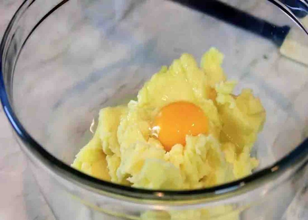 Mixing the ingredients for the mashed potato puffs 