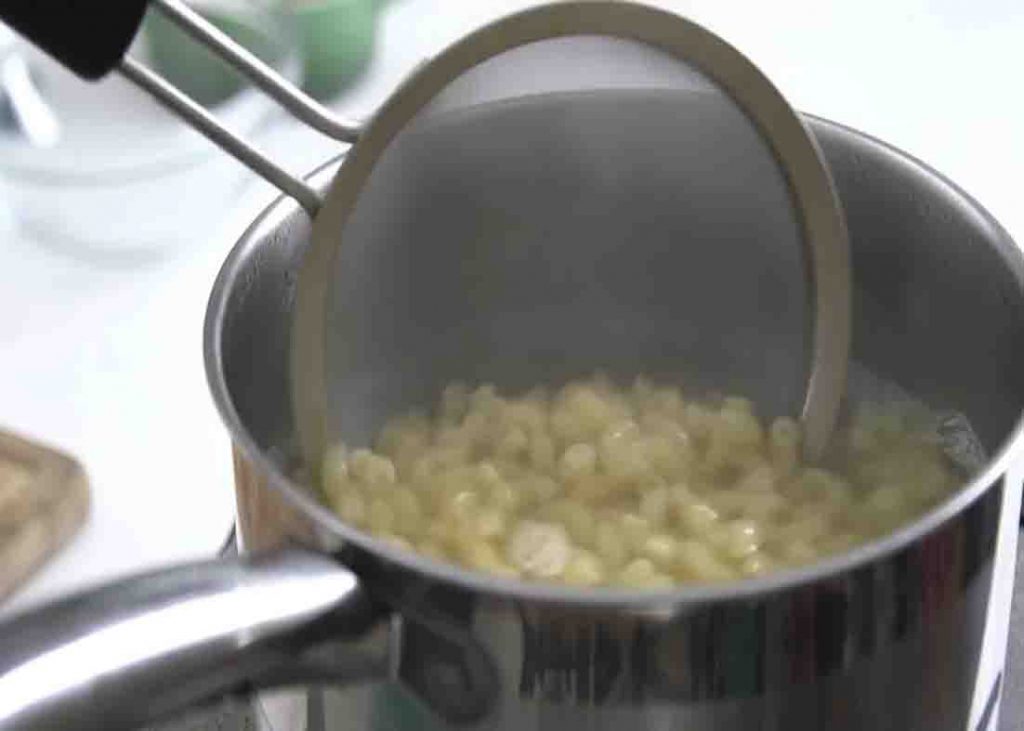 Cooking the elbow macaroni for the mini mac and cheese cups
