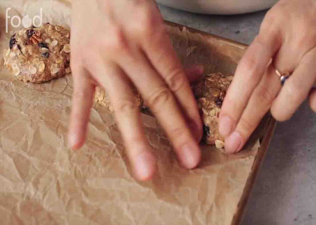 Placing the oatmeal cookies in the baking sheet