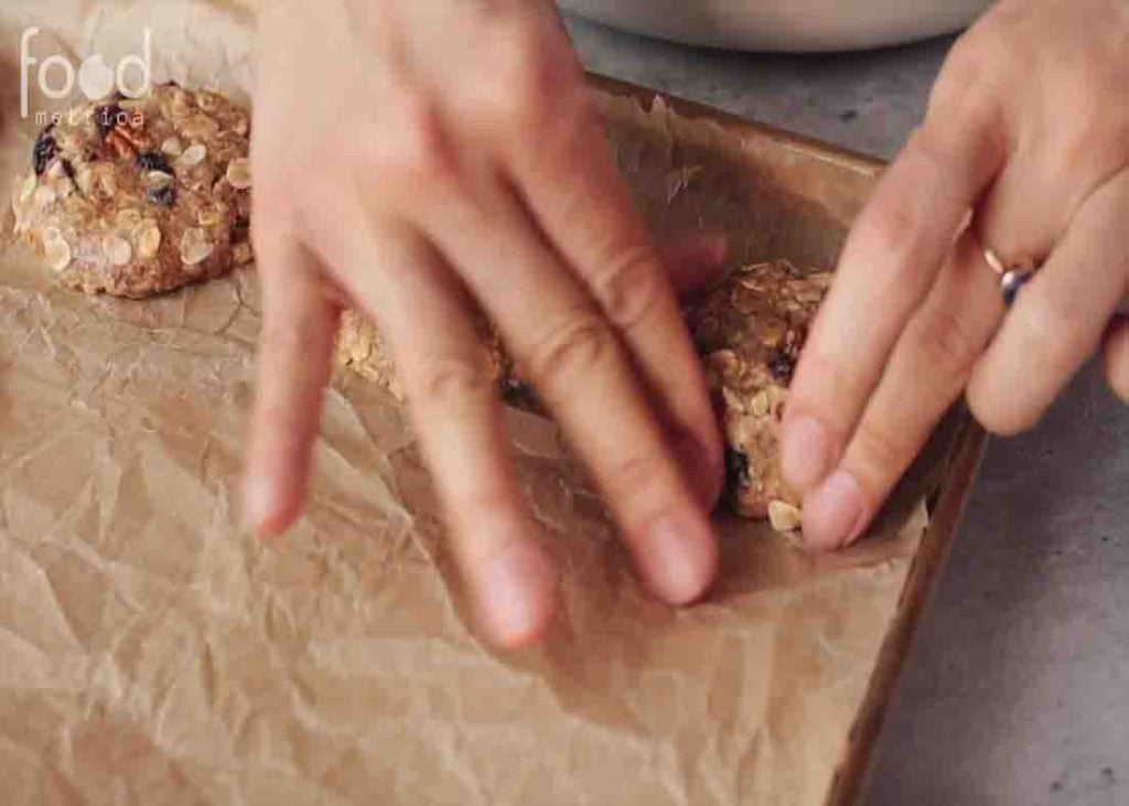 Placing the oatmeal cookies in the baking sheet