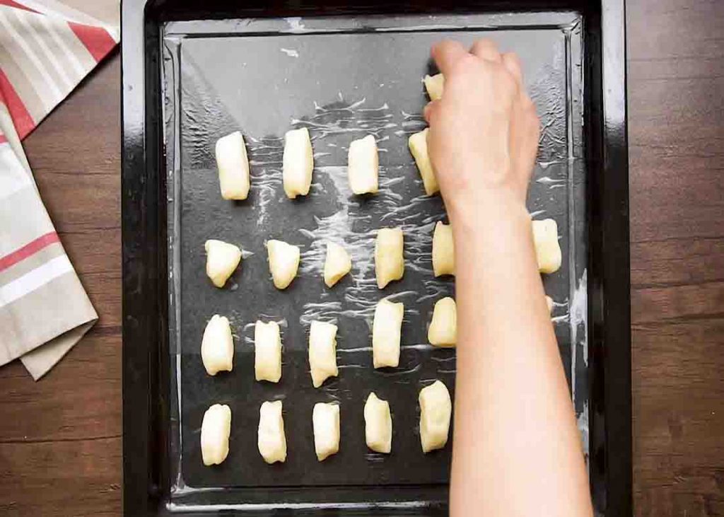 Lining up the pretzel bites dough in the baking sheet