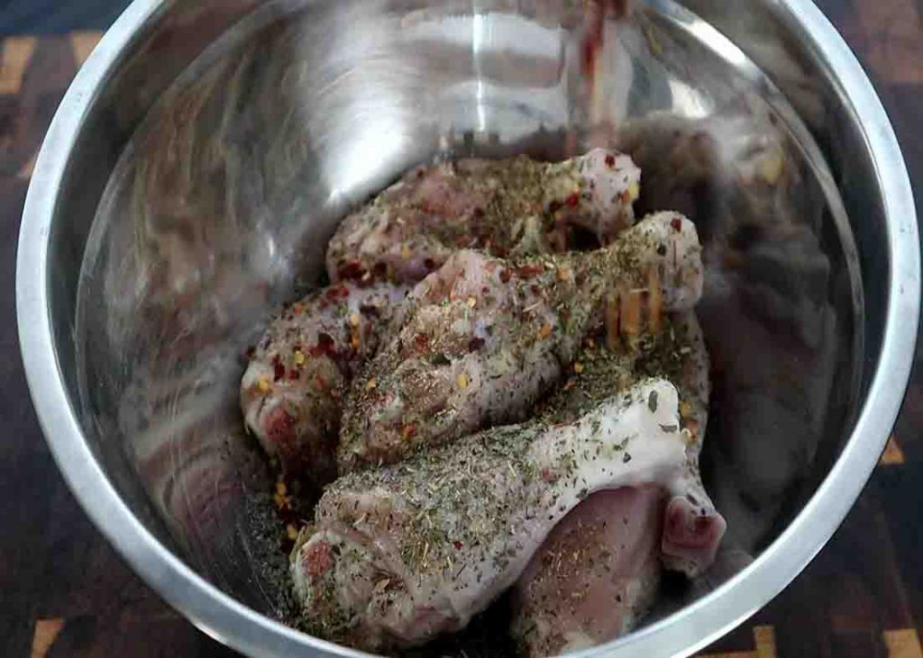 Seasoning the chicken drumsticks before slow cooking