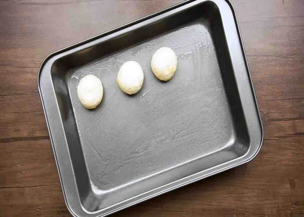 Placing the bread rolls in the baking tray
