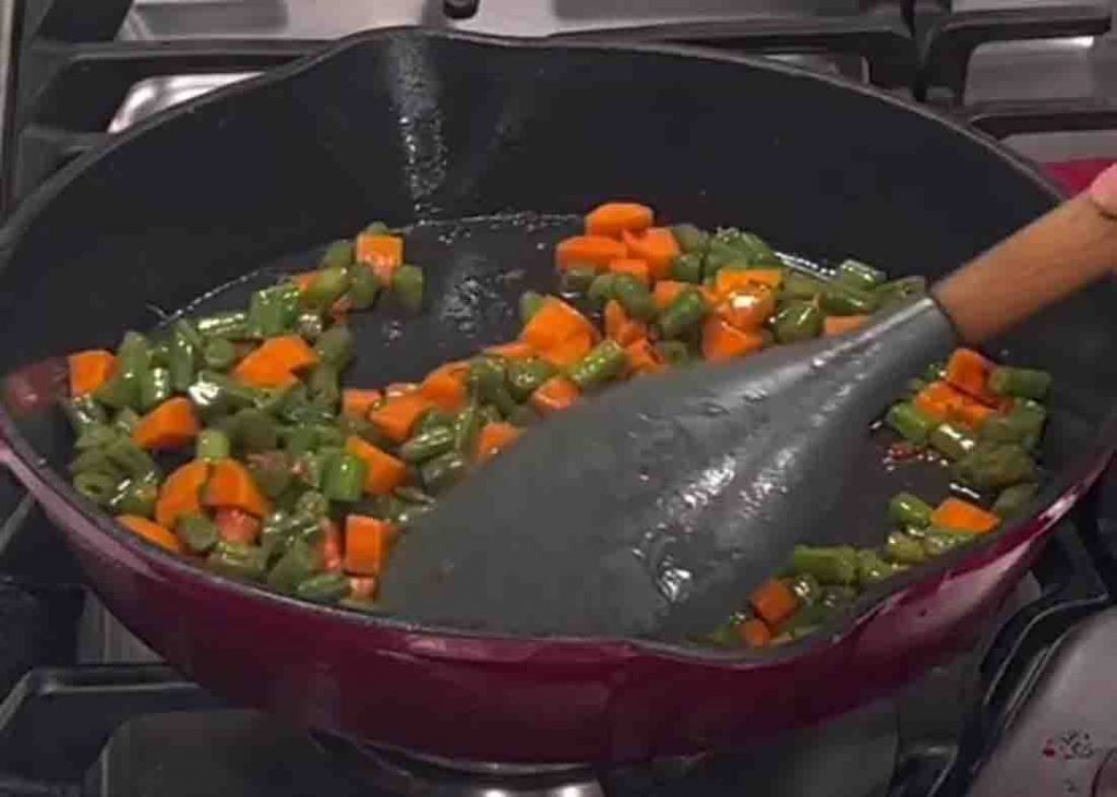 Stir frying the green beans and carrots