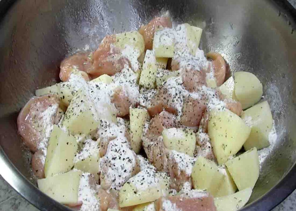 Seasoning the chicken and potato mixture