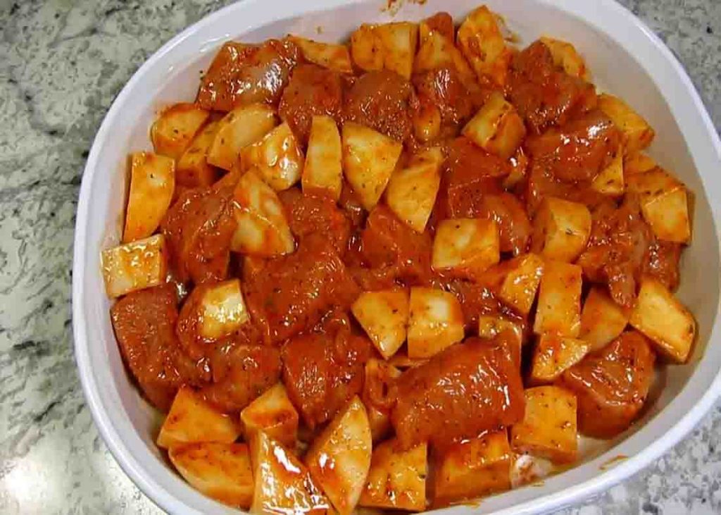 Transferring the chicken and potato mixture in the casserole dish